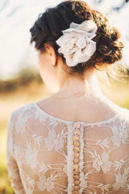Bride in the morning during wedding preparations. Flowers in the bride's hair