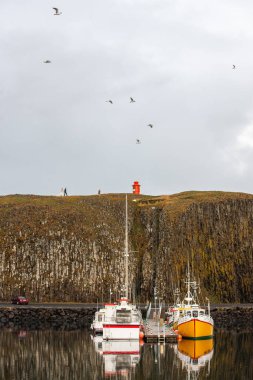 Bride and groom on their wedding day. Newlyweds walking near the lighthouse