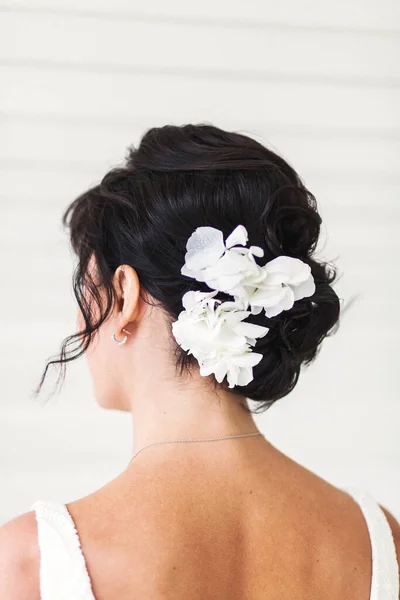 Bride in the morning during wedding preparations. Flowers in the bride\'s hair