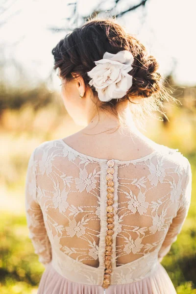 Bride in the morning during wedding preparations. Flowers in the bride\'s hair