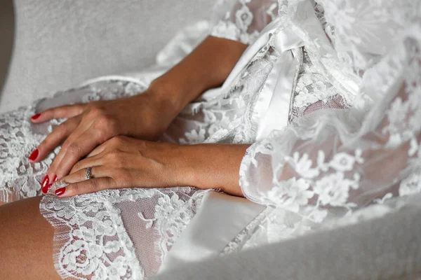 Bride in silk robe at wedding preparations.