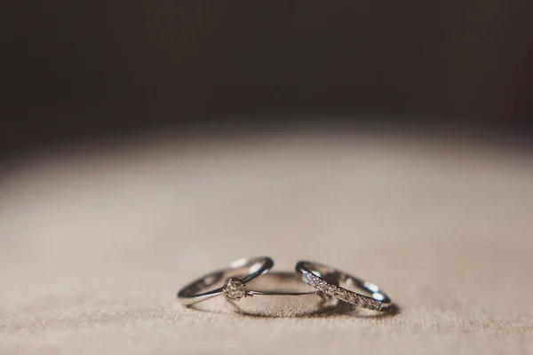 Three Wedding Rings Beige Background — Zdjęcie stockowe