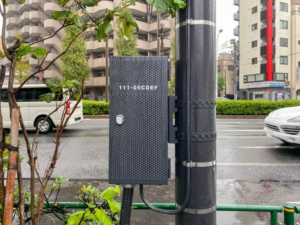 Tokyo, Japan - 23 November 2019: Recently installed, locked street cabinet housing control systems Stock Image