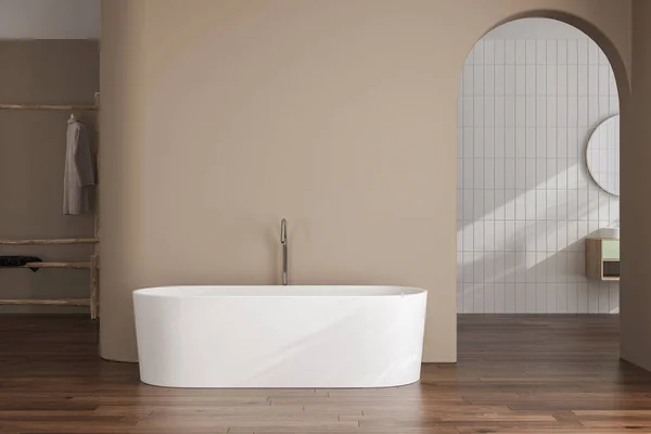 Beige minimalist bathroom interior with sun rays, cabinet, oval mirror, sink, white bathtub, parquet floor, tiles. Concept of minimal design. 3d rendering