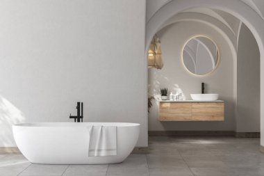 Modern yüzyılın ortalarında, minimalist banyo, küvet, beyaz dekor konsepti, beyaz duvarda asılı modern ahşap banyo dolabı, beton zemin. Sıcak banyo. 3d oluşturma