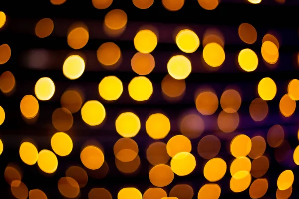 Defocused Gold abstract bokeh lights on black background. — Stock Photo, Image