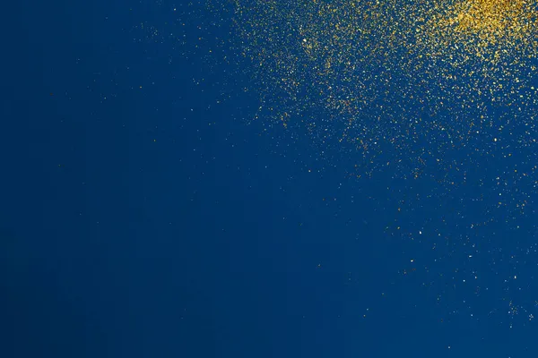 青い背景にクリスマスゴールドの輝き。休日の抽象的な質感 — ストック写真
