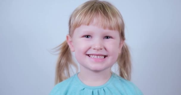 Portrait little blond Girl looking at camera and smile. Laughs Happily Child. — Vídeo de Stock