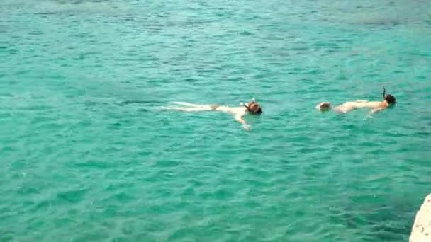 İnsanlar İyonya 'nın turkuvaz mavisi sularında yüzer ve şnorkelle yüzer.. — Stok video