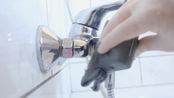 Woman in rubber gloves cleans shower watering can, bathroom sink in bathroom. — Stockvideo