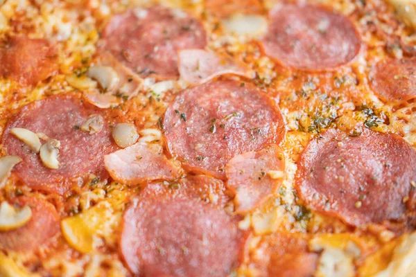 Hot meat pizza with salami, bacon and cheese . Selective focus. Top view