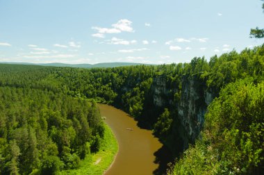 Milyonlarca yıllık bir kanyondaki bir nehir. Bir grup turist bir teknede..