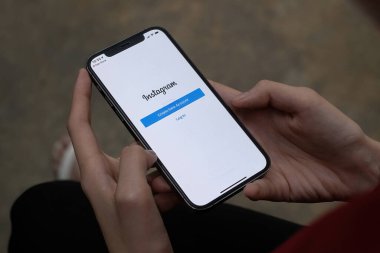 CHIANG MAI, THAILAND - 28 SEP 2021: iPhone 'da Instagram uygulaması kullanan bir kadın. Kısa video yapmak için Instagram makaraları.