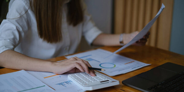 A businesswoman examines a financial chart in order to make arrangements. Investment concept for a business fund.