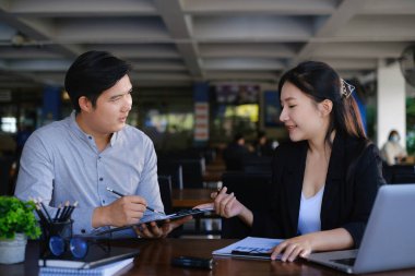 Analitik istihbarat konsepti. İş adamları grubu, toplantıda yatırım için dizüstü bilgisayarda mevcut mali ve ekonomik konuları tartışıyor.