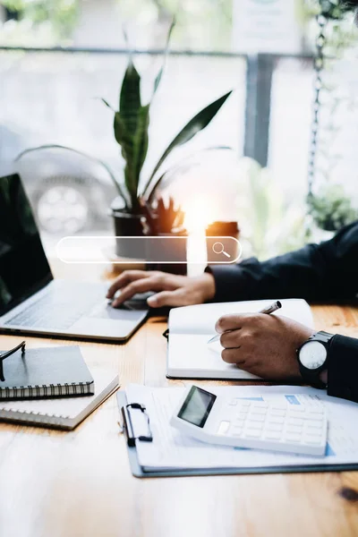 Businessman analyst financial advisor preparing statistical report searching documents on work desk, browsing information online by laptop computer. — 图库照片