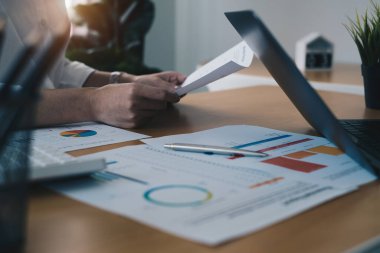 Business woman hand holding budget chart. Account or saving money or insurance concept.