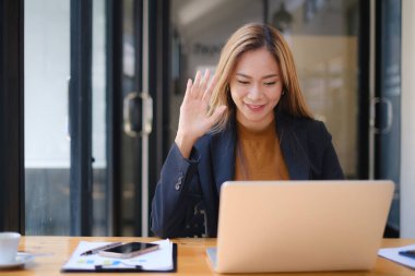 Çevrimiçi video konferansı ve dijital toplantı. İş kadını, merkez büroda ekiple iş görüşmeleri yapıyor..