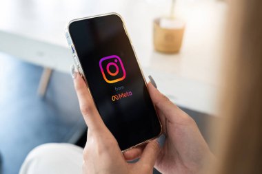 CHIANG MAI, THAILAND - MAR 05, 2022: iPhone 'da Instagram uygulaması kullanan bir kadın. Meta 'dan kısa videolar yapmak için Instagram makaraları.