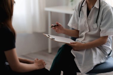 Doktor hastaya danışır ve klinikte sağlıklı besin sunar..