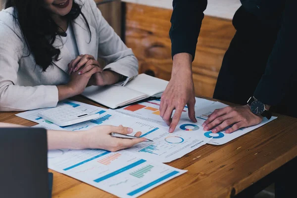 Bir grup Asyalı iş adamı yeni finansal projeyi analiz etmek ve planlamak için tartışıyor ve beyin fırtınası yapıyor.