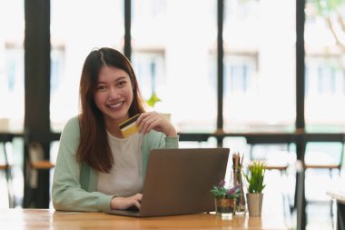 Woman using online payment and holding credit card. Online Shopping concept.