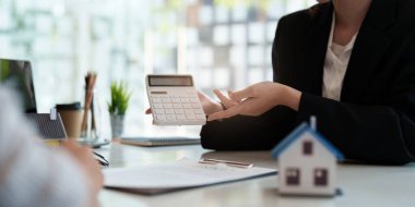 Close up Business woman or Real Estate agent explain signing agreement for buying house. Bank manager and real estate concept.