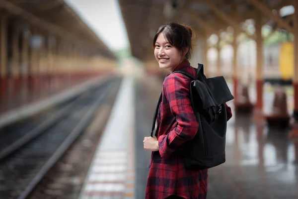 Beautiful traveler with backpack go to summer trip by train. Travel concept. — Zdjęcie stockowe