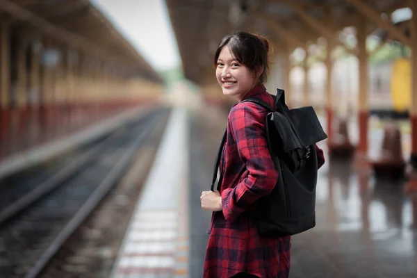 Beautiful traveler with backpack go to summer trip by train. Travel concept. — Stockfoto