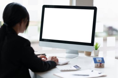 Businesswoman or Accountant working on desktop computer at office.