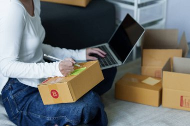 Çevrimiçi pazarlama kutu teslimatı konsepti. Asyalı Kadın küçük işletme serbest girişimi başlattı. Paket kutusu müşteriye teslim edilecek..