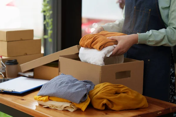 Online marketing packing box delivery concept. Asian Woman startup small business freelance with parcel box for deliver to customer.
