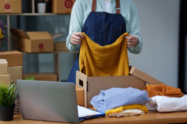 Online marketing packing box delivery concept. Asian Woman startup small business freelance with parcel box for deliver to customer.