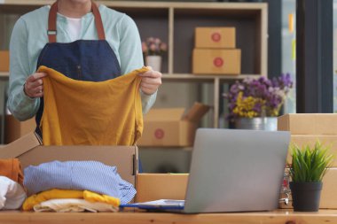 A portrait of Asian woman, e-commerce employee freelance with parcel box for deliver to customer. Online marketing packing box delivery concept.