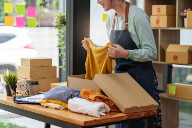 A portrait of Asian woman, e-commerce employee freelance with parcel box for deliver to customer. Online marketing packing box delivery concept.