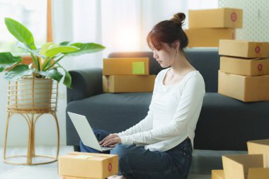 A portrait of Asian woman, e-commerce employee freelance with parcel box for deliver to customer. Online marketing packing box delivery concept.