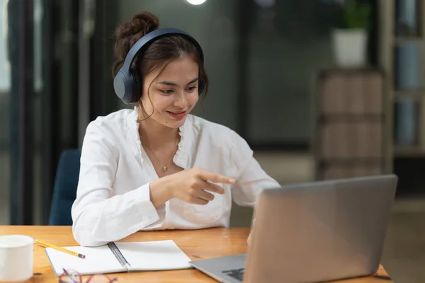 Portrait of woman video call with friend online by chat app. Woman using laptop computer video chat application