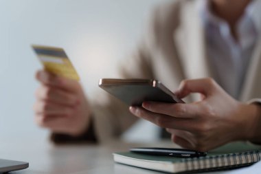 Young woman making online banking to payment with credit card and smartphone. Online Shopping concept