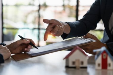 Real estate concept. Businessman pointing at agreement contract