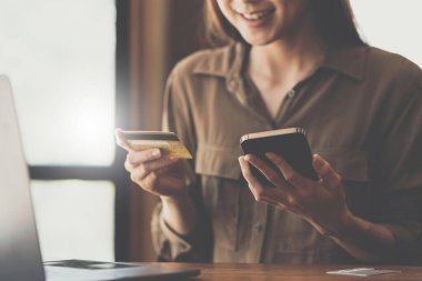 Woman using online payment and holding credit card. Online Shopping concept
