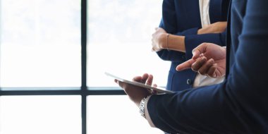 Businessman and Accountant checking data document on digital tablet.