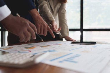 Group of coworkers having a meeting and working together in boardroom.