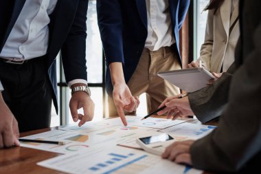 Group of coworkers having a meeting and working together in boardroom.