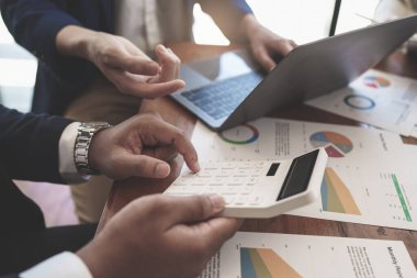 Account, audit and saving concept. Businessman do math and analyze with calculator.