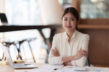 Modern business woman with financial document at office.