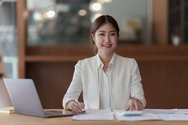Modern business woman with financial document at office.