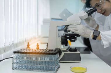 Scientist with a test tube containing cannabis extract.