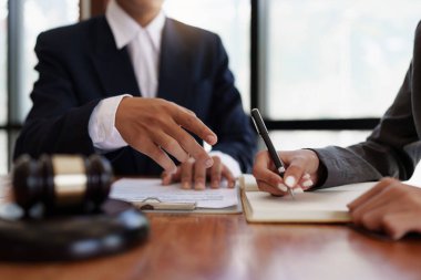 Business woman and lawyers discussing real estate agreement contract.