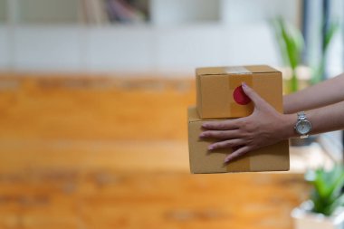 Asian woman employee freelance with parcel box for delivery to customer.