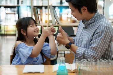 Kid and father doing science experiments. Education science concept.